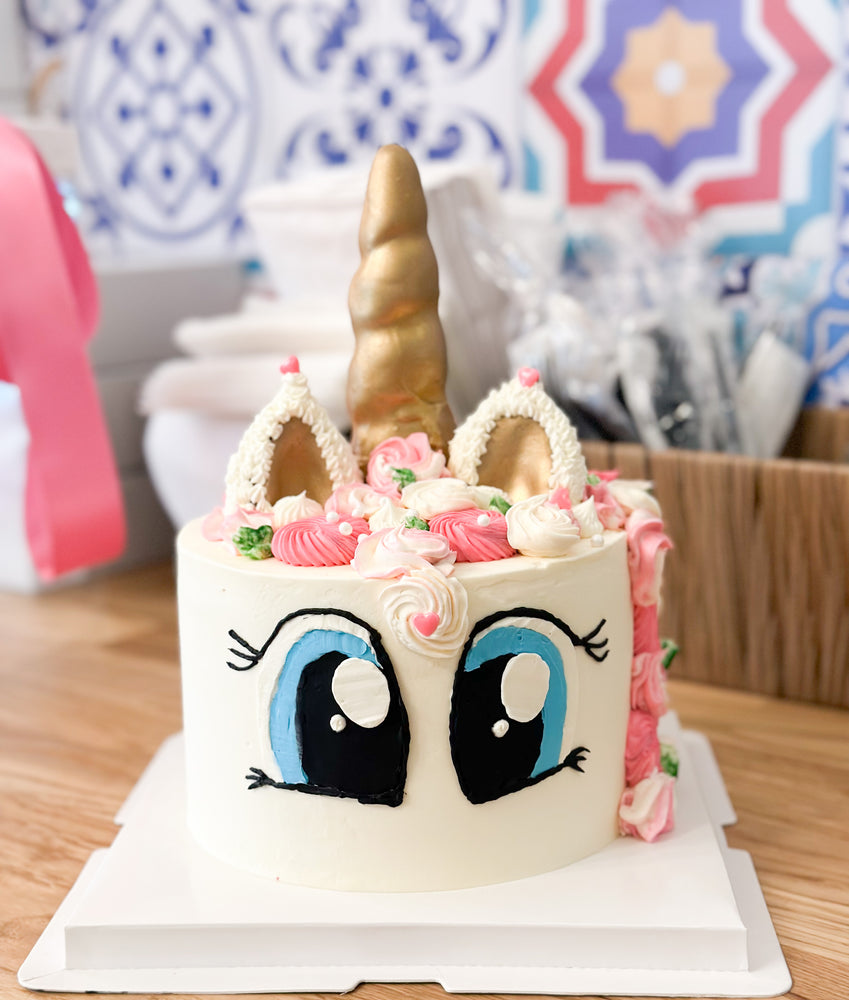 Unicorn cake with buttercream decoration big eyes, white with ears